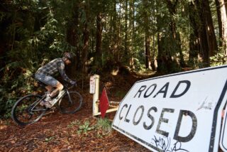 Marin Four Corners 2 rider skirting past a gate, Sonoma County, CA.