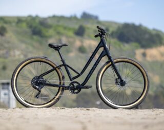 Marin Stinson ST2 profile, on the beach with a hillside backdrop.