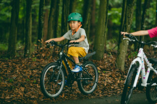 Boy riding a Donky Jr on a path, Japan.