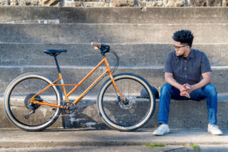 Man sitting on stairs next to a Marin Larkspur 2.