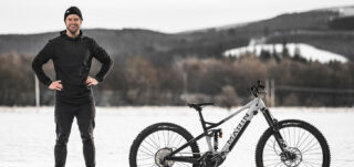 Rider Duncan Shaw standing next to an Alpine Trail E2.